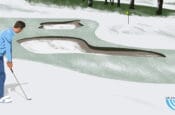 A golfer dressed stands on a snowy-like golf course, preparing to hit a shot with a golf club.